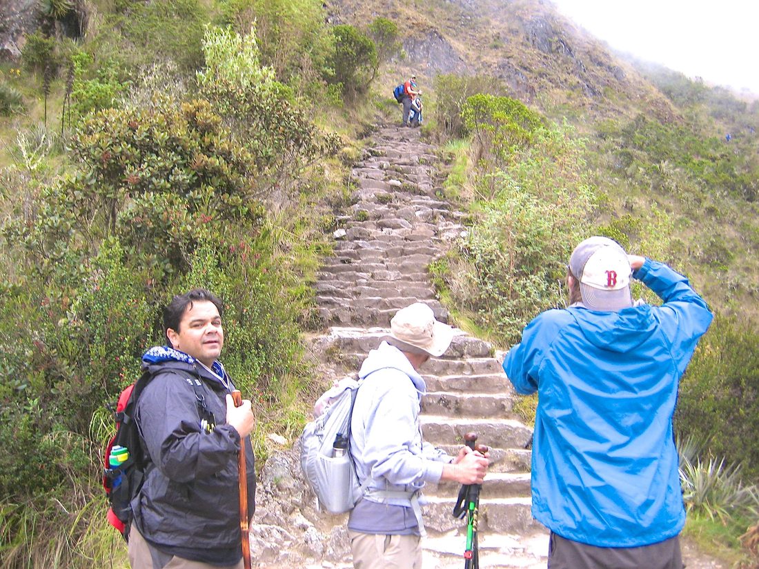 Gil on the stone stairs of the Inca Trail with fellow hikers